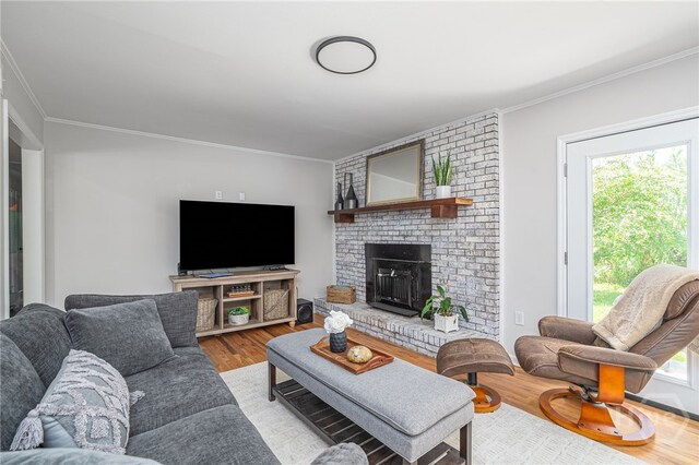 397 Hunt Dr, Savannah, GA 31406 - living area featuring ornamental molding, wood finished floors, healthy amount of natural light, and a brick fireplace
