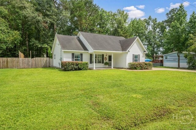 275 Carter St, Richmond Hill, GA 31324 - view of front of home featuring a shingled roof, covered porch, and view of scattered trees