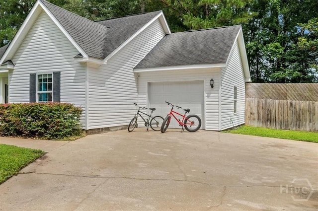 275 Carter St, Richmond Hill, GA 31324 - view of front of home featuring roof with shingles, an attached garage, and driveway