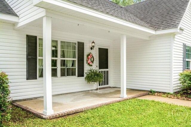 275 Carter St, Richmond Hill, GA 31324 - entrance to property featuring roof with shingles and a porch
