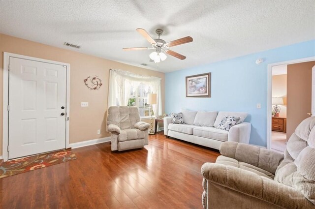 275 Carter St, Richmond Hill, GA 31324 - living room with a textured ceiling, ceiling fan, and wood finished floors