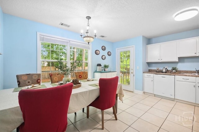 275 Carter St, Richmond Hill, GA 31324 - dining space with a chandelier, a textured ceiling, healthy amount of natural light, and light tile patterned floors