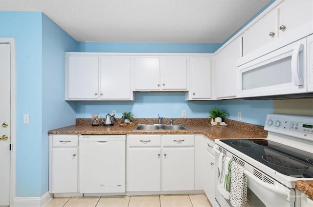 275 Carter St, Richmond Hill, GA 31324 - kitchen featuring white appliances, white cabinets, dark countertops, and light tile patterned floors