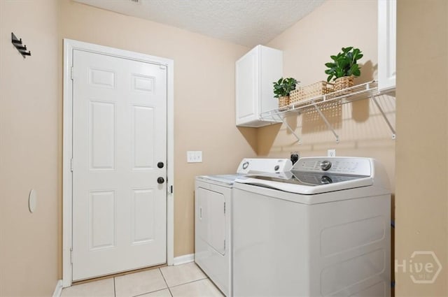 275 Carter St, Richmond Hill, GA 31324 - laundry room featuring cabinet space, washing machine and dryer, light tile patterned flooring, and a textured ceiling