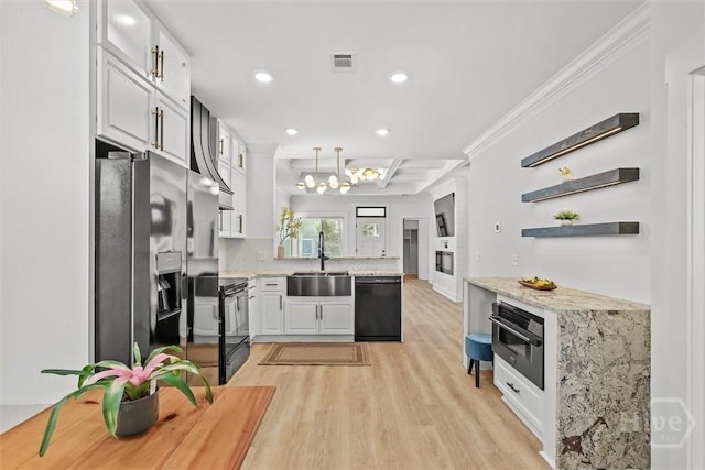 1212 Seiler Ave, Savannah, GA 31404 - kitchen featuring black appliances, light wood-type flooring, white cabinetry, recessed lighting, and a chandelier