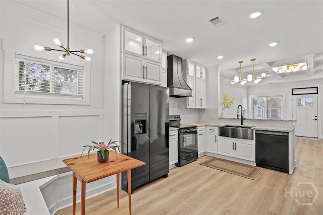 1212 Seiler Ave, Savannah, GA 31404 - kitchen featuring black appliances, a chandelier, premium range hood, coffered ceiling, and plenty of natural light