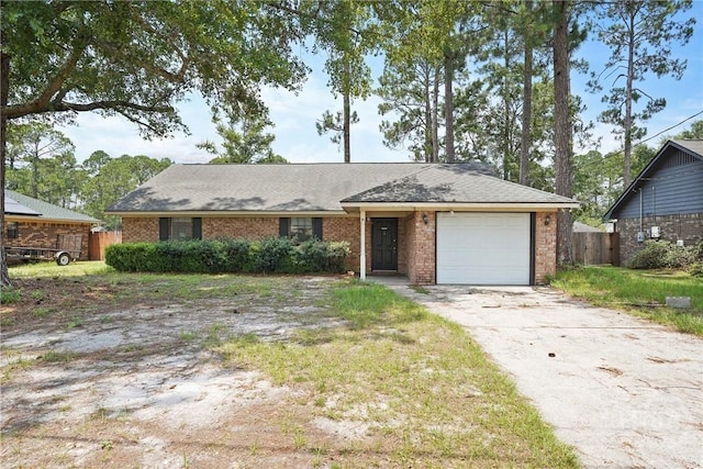 702 Friar Tuck Ln, Hinesville, GA 31313 - single story home with a garage, driveway, brick siding, and roof with shingles