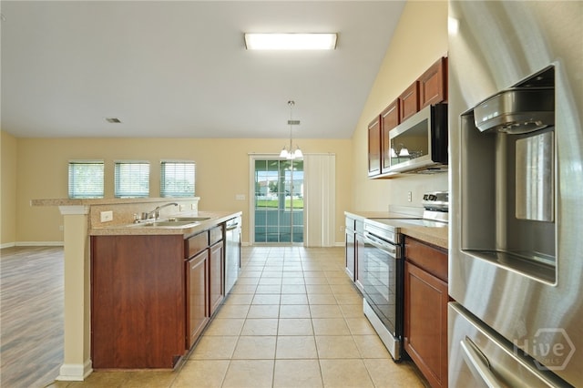 31 Cottingham Way, Pooler, GA 31322 - kitchen with stainless steel appliances, light countertops, lofted ceiling, decorative light fixtures, and an island with sink