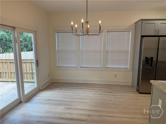 2310 Coakley St, Savannah, GA 31404 - unfurnished dining area with a chandelier and light wood-style flooring