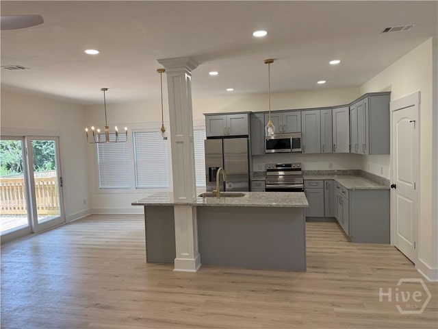 2310 Coakley St, Savannah, GA 31404 - kitchen featuring stainless steel appliances, gray cabinets, light stone countertops, light wood-style floors, and recessed lighting