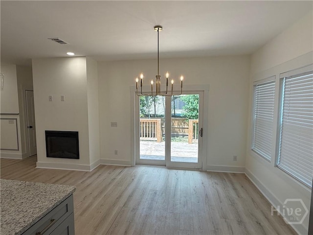 2310 Coakley St, Savannah, GA 31404 - unfurnished dining area featuring light wood-style floors, a chandelier, a fireplace, and recessed lighting