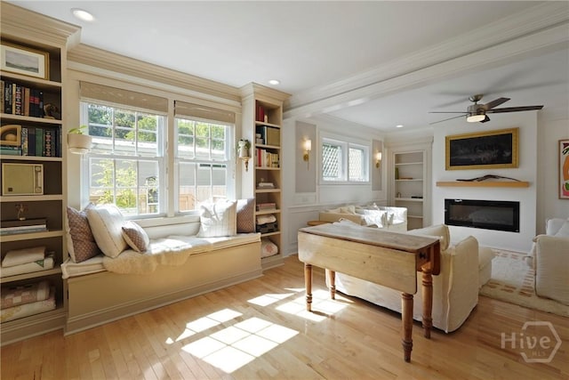 209 E 66th St, Savannah, GA 31405 - living room with a glass covered fireplace, hardwood / wood-style floors, crown molding, healthy amount of natural light, and built in features