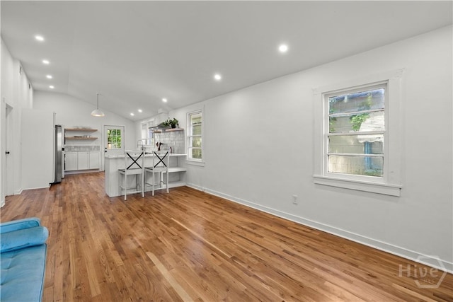 731 E 34th St, Savannah, GA 31401 - living room featuring light wood-type flooring, vaulted ceiling, and recessed lighting