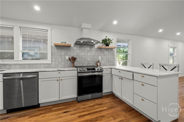 731 E 34th St, Savannah, GA 31401 - kitchen featuring stainless steel appliances, open shelves, a peninsula, backsplash, and plenty of natural light