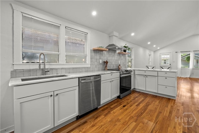 731 E 34th St, Savannah, GA 31401 - kitchen with appliances with stainless steel finishes, a peninsula, wood finished floors, open shelves, and light countertops