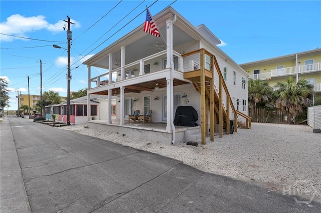 13 Izlar Ave, Tybee Island, GA 31328 - back of property with a ceiling fan, a patio area, a balcony, and stairway