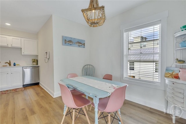 13 Izlar Ave, Tybee Island, GA 31328 - dining room with a chandelier and light wood-style flooring