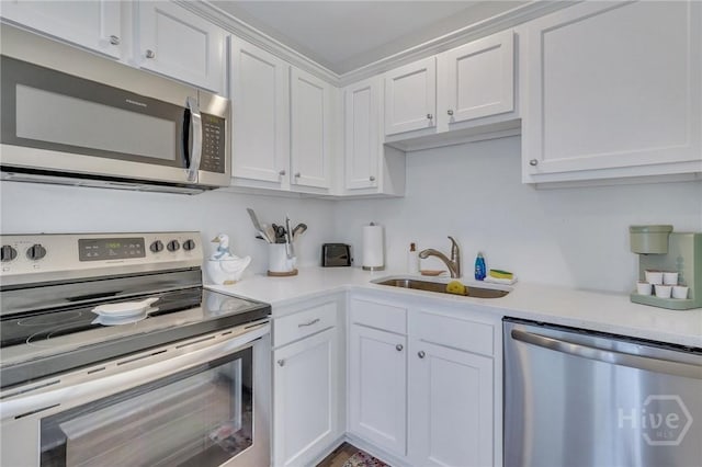 13 Izlar Ave, Tybee Island, GA 31328 - kitchen featuring appliances with stainless steel finishes, white cabinets, and light countertops