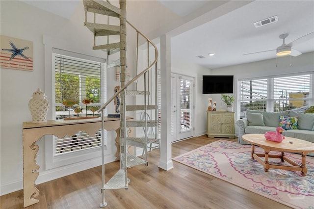 13 Izlar Ave, Tybee Island, GA 31328 - living room with stairs, wood finished floors, and a ceiling fan
