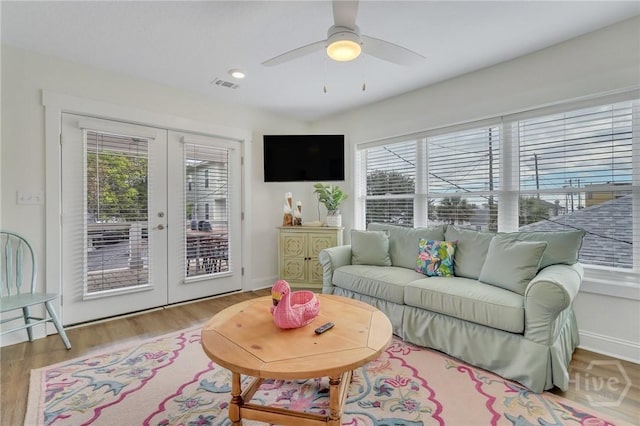 13 Izlar Ave, Tybee Island, GA 31328 - living room with french doors, plenty of natural light, wood finished floors, and ceiling fan