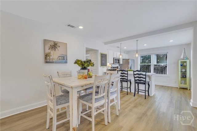 13 Izlar Ave, Tybee Island, GA 31328 - dining area with light wood-style flooring and recessed lighting