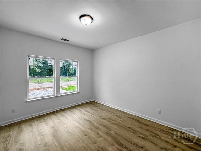 1031 Milton St, Savannah, GA 31405 - empty room featuring wood finished floors and baseboards