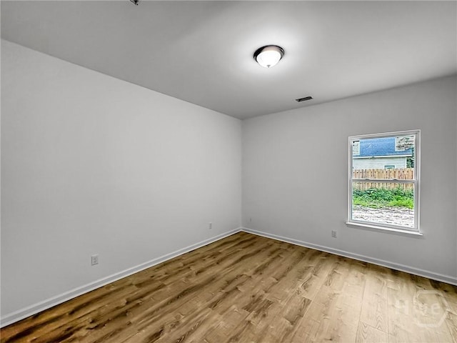 1031 Milton St, Savannah, GA 31405 - spare room with wood finished floors and baseboards