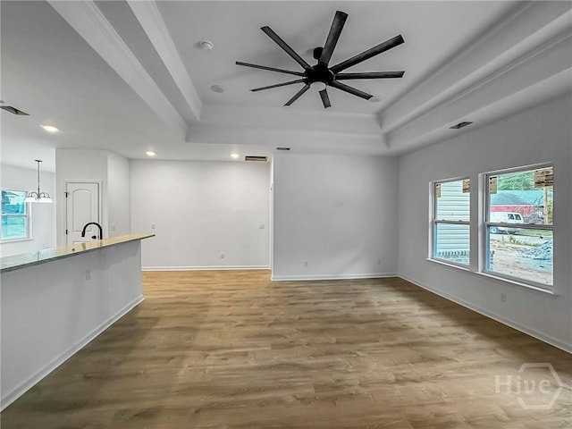 1031 Milton St, Savannah, GA 31405 - unfurnished living room with a tray ceiling, recessed lighting, wood finished floors, and a ceiling fan