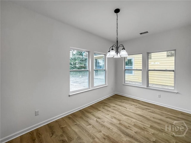 1031 Milton St, Savannah, GA 31405 - unfurnished dining area with a chandelier and wood finished floors