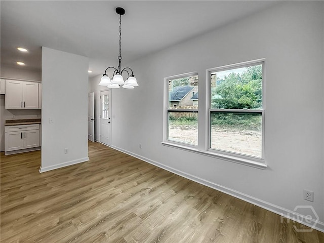 1031 Milton St, Savannah, GA 31405 - unfurnished dining area with light wood finished floors, recessed lighting, and a chandelier