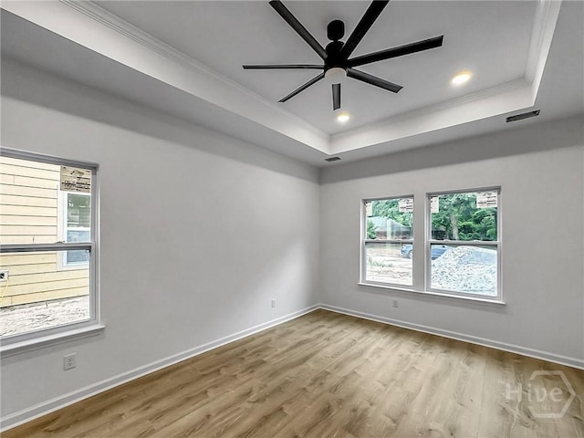 1031 Milton St, Savannah, GA 31405 - empty room featuring a raised ceiling, plenty of natural light, ornamental molding, wood finished floors, and recessed lighting