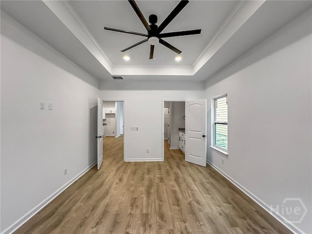 1031 Milton St, Savannah, GA 31405 - unfurnished bedroom featuring a tray ceiling, ornamental molding, and wood finished floors