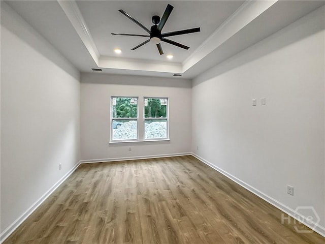1031 Milton St, Savannah, GA 31405 - empty room featuring a tray ceiling, wood finished floors, crown molding, ceiling fan, and recessed lighting