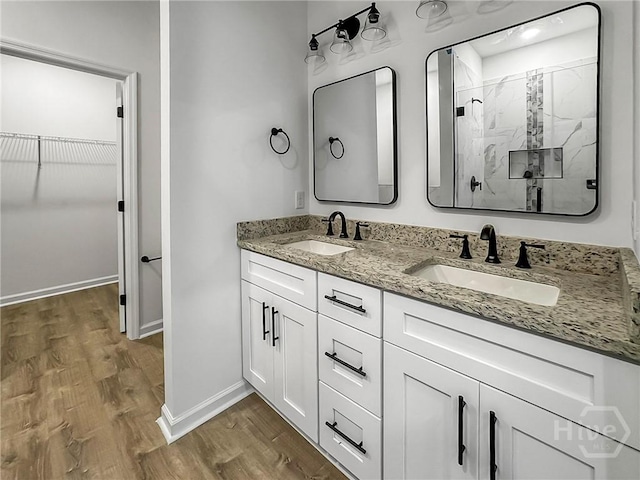 1031 Milton St, Savannah, GA 31405 - full bath featuring a marble finish shower, wood finished floors, double vanity, and a spacious closet