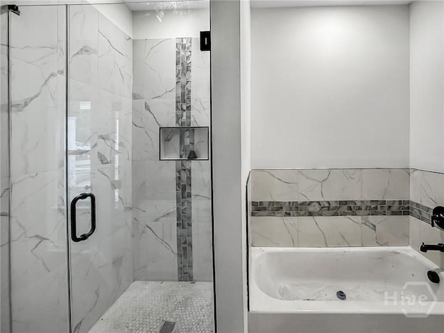 1031 Milton St, Savannah, GA 31405 - bathroom featuring a bath and a marble finish shower