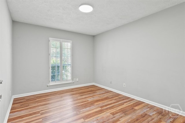 904 Mill Dr, Savannah, GA 31419 - empty room with light wood-style flooring and a textured ceiling