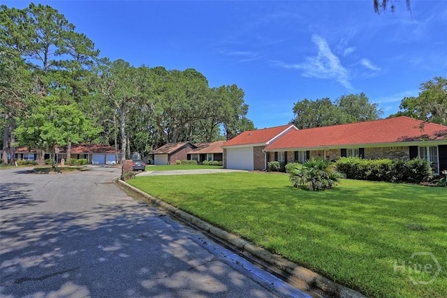 904 Mill Dr, Savannah, GA 31419 - ranch-style home with a garage, concrete driveway, a front yard, and brick siding