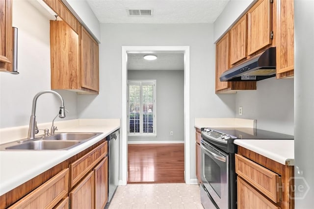 904 Mill Dr, Savannah, GA 31419 - kitchen featuring appliances with stainless steel finishes, under cabinet range hood, light countertops, light tile patterned floors, and a textured ceiling
