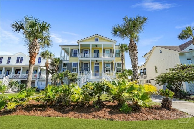 3 Palmwood Ct, Tybee Island, GA 31328 - coastal home with covered porch, a balcony, and stairway