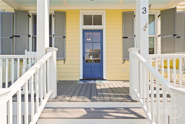 3 Palmwood Ct, Tybee Island, GA 31328 - view of exterior entry featuring a porch