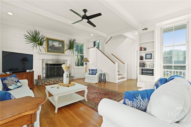 3 Palmwood Ct, Tybee Island, GA 31328 - living room with wood finished floors, stairs, a ceiling fan, a fireplace, and a wood ceiling with exposed beams