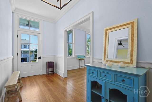 3 Palmwood Ct, Tybee Island, GA 31328 - entryway featuring a wainscoted wall, ornamental molding, and light wood-type flooring
