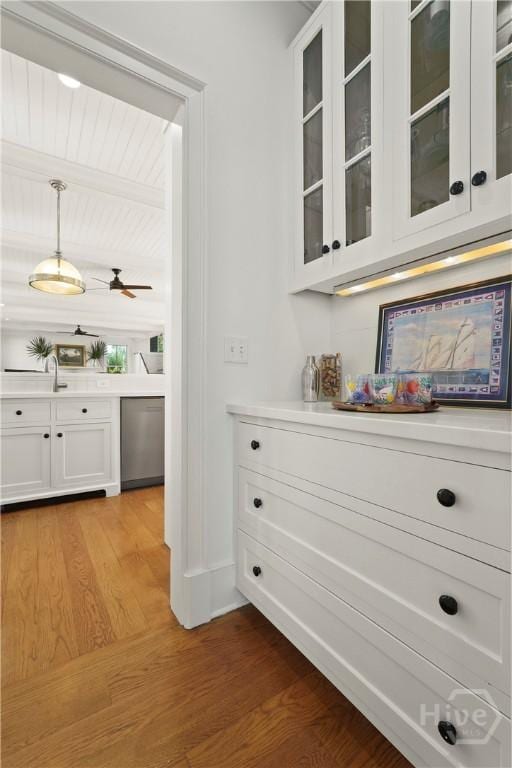 3 Palmwood Ct, Tybee Island, GA 31328 - bar area with dishwasher, light wood-style floors, hanging light fixtures, a ceiling fan, and beam ceiling