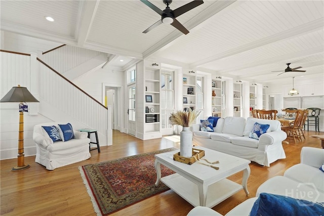 3 Palmwood Ct, Tybee Island, GA 31328 - living room with ceiling fan, stairway, beamed ceiling, wood finished floors, and built in shelves