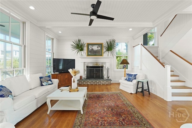 3 Palmwood Ct, Tybee Island, GA 31328 - living area with stairs, plenty of natural light, wood finished floors, crown molding, and a brick fireplace