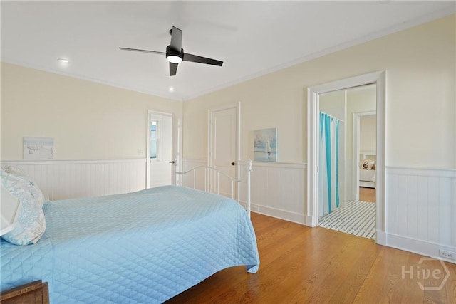 3 Palmwood Ct, Tybee Island, GA 31328 - bedroom featuring a wainscoted wall, wood finished floors, and a ceiling fan