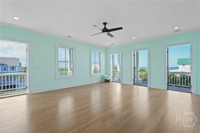 3 Palmwood Ct, Tybee Island, GA 31328 - unfurnished living room with wood finished floors, plenty of natural light, ceiling fan, and recessed lighting