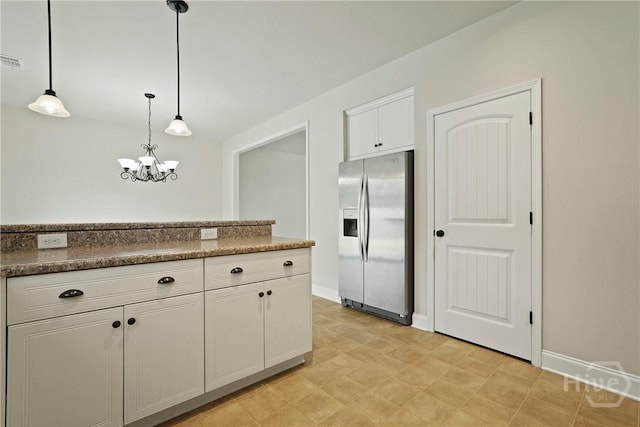 153 Whirlwind Way, Guyton, GA 31312 - kitchen featuring stainless steel fridge with ice dispenser, white cabinets, a chandelier, decorative light fixtures, and dark countertops