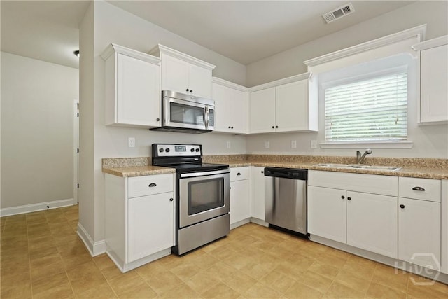 153 Whirlwind Way, Guyton, GA 31312 - kitchen with appliances with stainless steel finishes, white cabinets, light countertops, and light floors