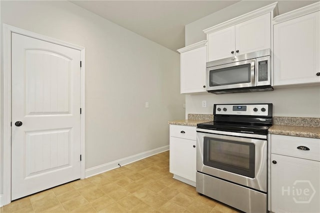 153 Whirlwind Way, Guyton, GA 31312 - kitchen with stainless steel appliances, white cabinets, light countertops, and light flooring